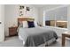 Cozy bedroom with a wood bed frame and large window at 1262 N Stuart St # 2, Denver, CO 80204