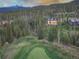 Aerial view of home on golf course with mountain backdrop at 245 Fairways Dr, Breckenridge, CO 80424
