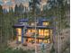 Stunning aerial view of a modern home nestled in the mountains at 245 Fairways Dr, Breckenridge, CO 80424