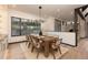 Bright dining room with large window and wooden table, seating six at 245 Fairways Dr, Breckenridge, CO 80424