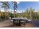 Deck with mountain views and outdoor dining set; perfect for entertaining at 245 Fairways Dr, Breckenridge, CO 80424