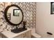 Chic bathroom with geometric tile, black vessel sink, and round mirror at 245 Fairways Dr, Breckenridge, CO 80424