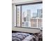 Bedroom with stunning city skyline view from large window at 1133 14Th St # 2620, Denver, CO 80202