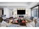 Living room with modern fireplace, large TV, and city views at 1133 14Th St # 2620, Denver, CO 80202