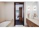 Bathroom with double vanity and view into bedroom at 1133 14Th St # 2620, Denver, CO 80202