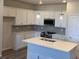 Modern kitchen with white cabinets, gray backsplash, and quartz countertops at 8826 Yellowcress St, Littleton, CO 80125