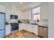 Modern kitchen with stainless steel appliances and white cabinetry at 1998 Foxtail Ln # B, Lafayette, CO 80026