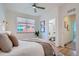 Bright bedroom with white walls and light wood floors and en-suite bathroom at 1998 Foxtail Ln # B, Lafayette, CO 80026