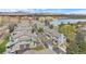 Aerial view of townhouses near a lake with mountain views in the background at 10330 W Jewell Ave # A, Lakewood, CO 80232