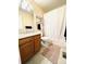 Clean bathroom with wood cabinets and a shower/tub combo at 10330 W Jewell Ave # A, Lakewood, CO 80232