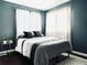 Bright bedroom with a double bed and dark blue walls at 10330 W Jewell Ave # A, Lakewood, CO 80232