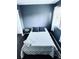 Simple bedroom with a double bed and dark blue walls at 10330 W Jewell Ave # A, Lakewood, CO 80232