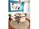 Dining area with a round table and four chairs, teal walls and hardwood floor at 10330 W Jewell Ave # A, Lakewood, CO 80232