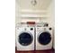 Bright laundry room with washer, dryer, and shelving at 10330 W Jewell Ave # A, Lakewood, CO 80232
