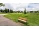 Peaceful park with walking paths, bench, and mature trees at 10330 W Jewell Ave # A, Lakewood, CO 80232