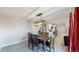 Bright dining area with a modern light fixture and access to the backyard at 7248 S Broadway, Centennial, CO 80122