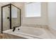 Elegant bathroom featuring a soaking tub and a walk-in shower at 42996 Colonial Trl, Elizabeth, CO 80107