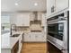Modern kitchen with white cabinets and stainless steel appliances at 42996 Colonial Trl, Elizabeth, CO 80107