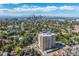 Aerial view of apartment building with city skyline in the background at 1260 York St # 105, Denver, CO 80206