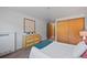 Bright bedroom with wood closet doors, dresser, and neutral decor at 1260 York St # 105, Denver, CO 80206