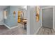 Entryway with view of kitchen and dining area, featuring light walls and hardwood floors at 1260 York St # 105, Denver, CO 80206