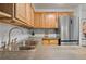 Stainless steel sink and appliances in this updated kitchen with wood cabinets at 1260 York St # 105, Denver, CO 80206