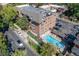 Aerial view showing building, pool, and surrounding neighborhood at 1260 York St # 105, Denver, CO 80206