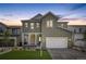 Two-story home with gray siding, white trim, and a two-car garage at 11076 Star Fall St, Littleton, CO 80125