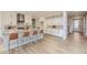 Bright kitchen featuring white cabinets, center island, and quartz countertops at 11076 Star Fall St, Littleton, CO 80125