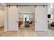 Bright home office with barn doors and hardwood floors at 11076 Star Fall St, Littleton, CO 80125