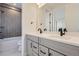 Bathroom with dual vanity, modern fixtures and gray tile at 11076 Star Fall St, Littleton, CO 80125