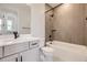 Clean bathroom with tub, shower, and gray tile at 11076 Star Fall St, Littleton, CO 80125