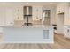 Modern kitchen with white cabinets, large island, and stainless steel appliances at 11076 Star Fall St, Littleton, CO 80125