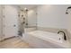 Spa-like bathroom with soaking tub, walk-in shower, and modern fixtures at 11076 Star Fall St, Littleton, CO 80125