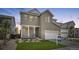 Two-story home with gray siding, white trim, and a two-car garage at 11076 Star Fall St, Littleton, CO 80125
