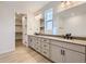 Elegant bathroom with dual vanity, walk-in closet, and modern fixtures at 11076 Star Fall St, Littleton, CO 80125