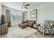 Living room with leather sofa, arm chair, and ceiling fan at 16139 E Elk Dr, Denver, CO 80239