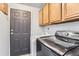 Laundry room with washer, dryer, and cabinets at 9132 Fayette St, Denver, CO 80260