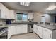 Modern kitchen with white cabinets and gray countertops at 5724 S Bahama W Cir, Aurora, CO 80015