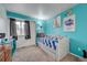 Bedroom with daybed, teal walls, and window with curtains at 5724 S Bahama W Cir, Aurora, CO 80015