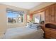 Bright bedroom with built-in shelving and a view of the backyard at 8796 E 150Th Ct, Thornton, CO 80602