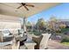 Relaxing covered patio with outdoor furniture and ceiling fan at 8796 E 150Th Ct, Thornton, CO 80602