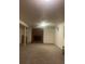 Finished basement with a brick fireplace and carpeted floors at 1515 S Monaco Pkwy, Denver, CO 80224