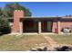 Brick home with covered patio, stone walkway, and a small yard at 1515 S Monaco Pkwy, Denver, CO 80224