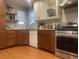 Modern kitchen with wood cabinets, granite countertops, and stainless steel appliances at 1515 S Monaco Pkwy, Denver, CO 80224