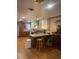 Updated kitchen with granite countertops, wood cabinetry and island at 1515 S Monaco Pkwy, Denver, CO 80224