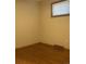 Small bedroom with wood floors and neutral colored walls at 1515 S Monaco Pkwy, Denver, CO 80224