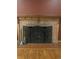 Brick fireplace with ornate screen and wooden mantel at 1515 S Monaco Pkwy, Denver, CO 80224