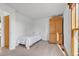 Small bedroom with a twin bed, wooden armoire, and carpet flooring at 112 W Elm St, Louisville, CO 80027