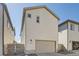 Attached garage with light beige exterior siding at 5980 Sima Cir, Lone Tree, CO 80124